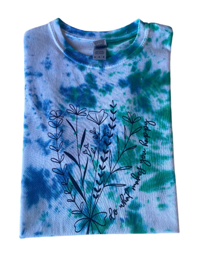 Size Large, Folded Blue, Green and White short sleeve tie-dye t-shirt with a floral image and cursive test "Do What Makes You Happy" 